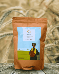 The Deep Soil Barley Flour Jau Ka Atta package on wooden table with sunlit barley field background
