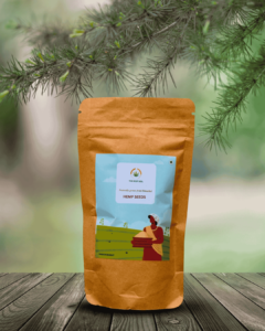 The Deep Soil Hemp Seeds brown paper package on a wooden table with pine tree branches background