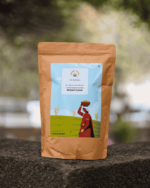 The Deep Soil Wheat Flour Bharat Ka Gehun Ka Atta brown paper package on a stone surface with nature background